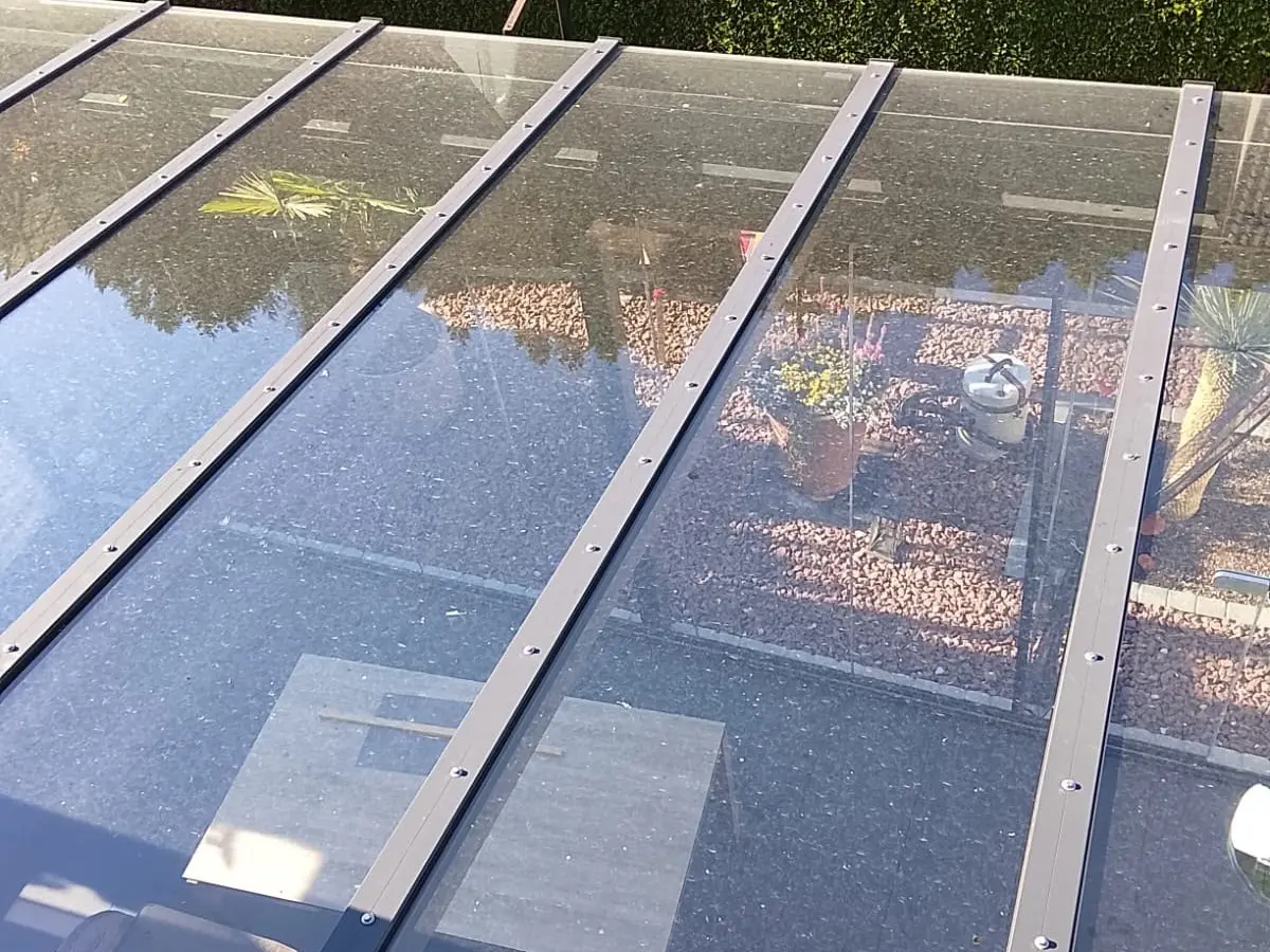 Verschmutztes Glasdach einer Terrassenüberdachung vor der Reinigung